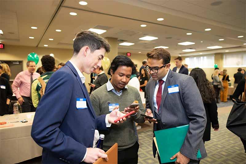 Three Skidmore students looking conversing at a Career Jam event